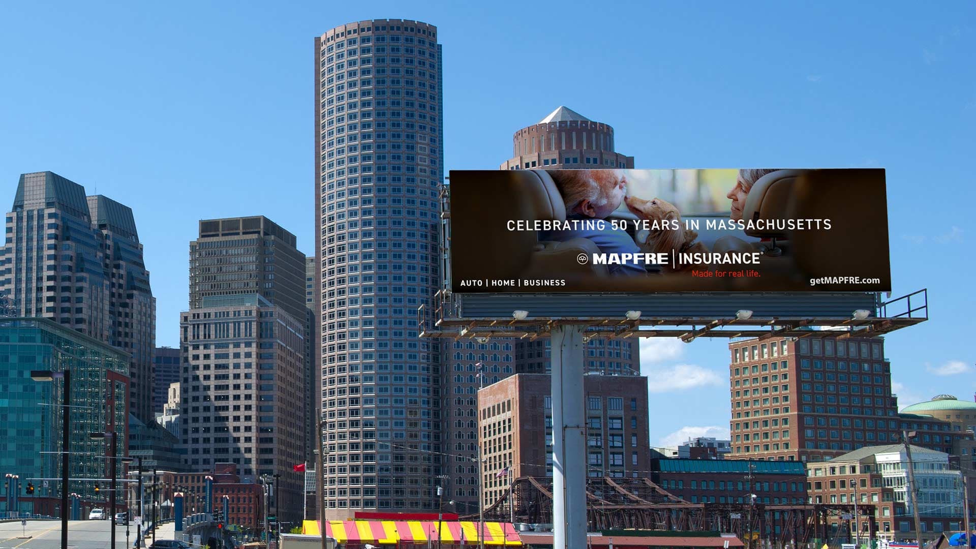A Mapfre Insurance billboard OOH showing in front of the city skyline.