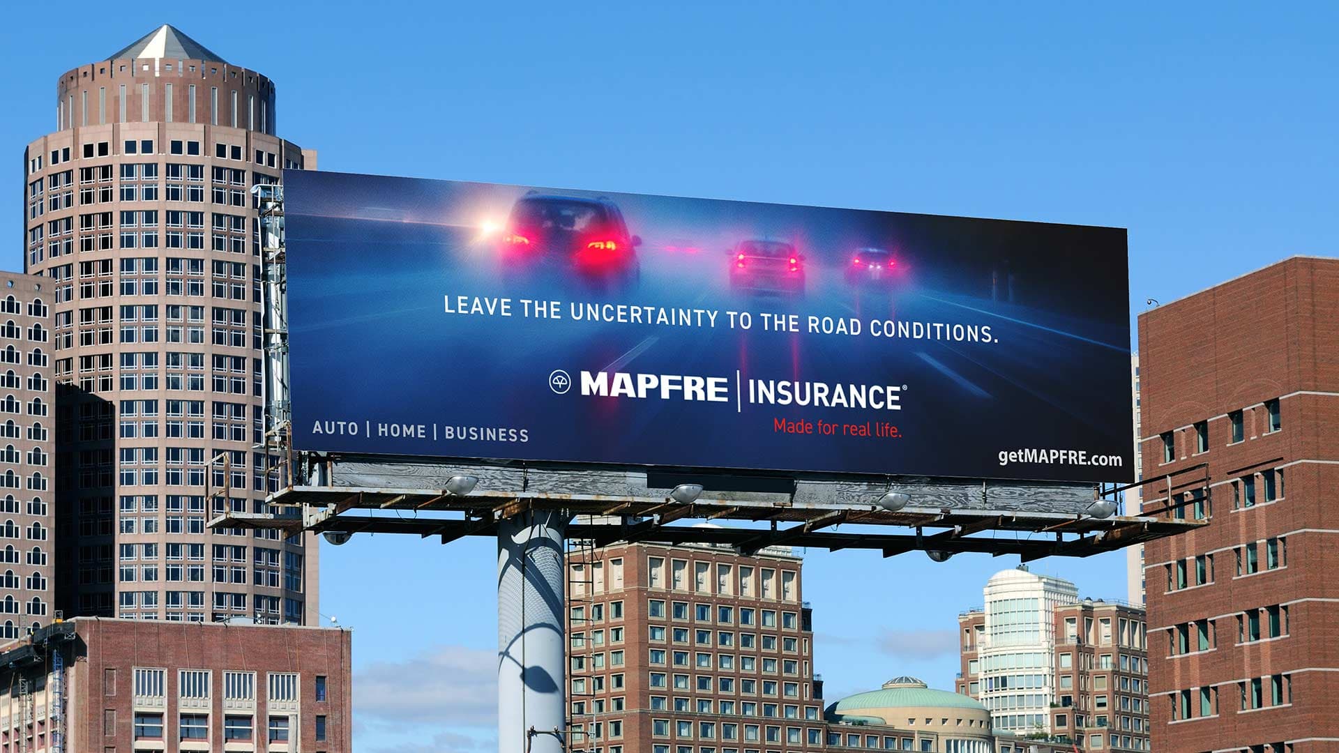 A Mapfre Insurance billboard OOH showing in front of the city skyline.