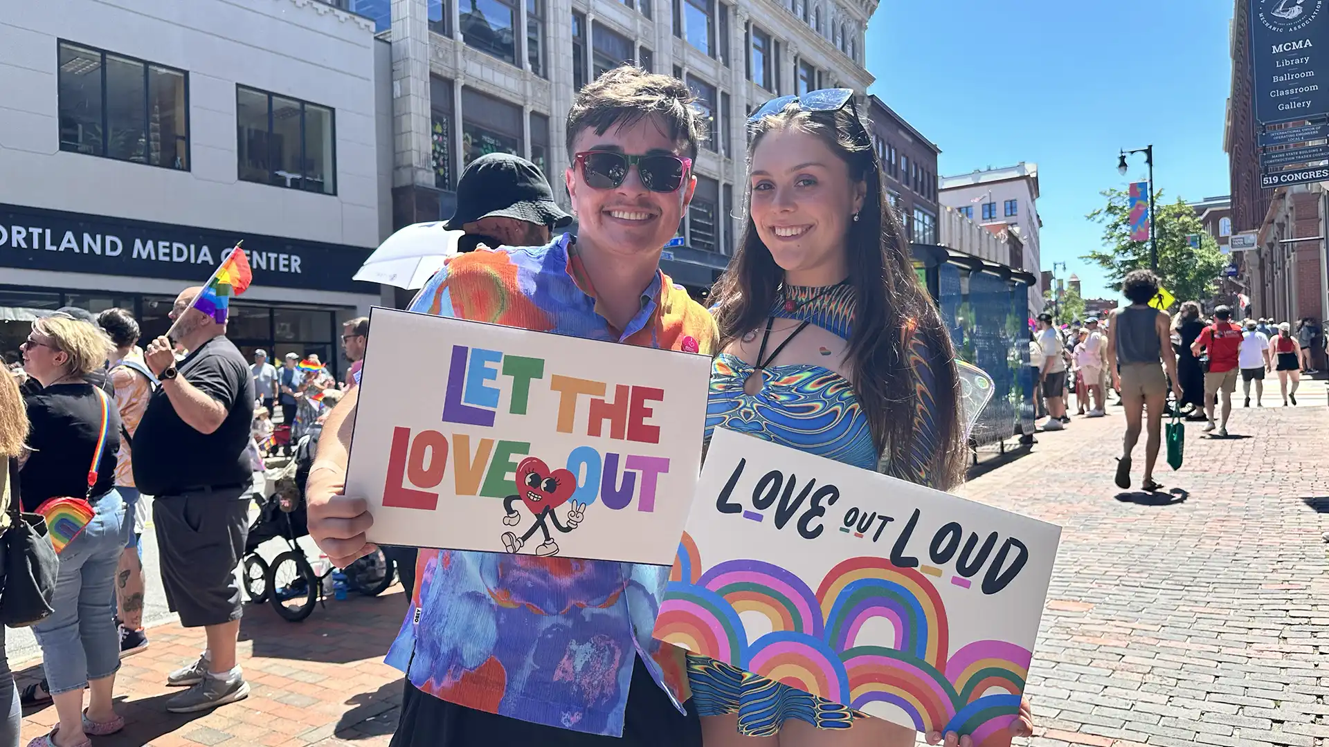 Pride parade goers with posters