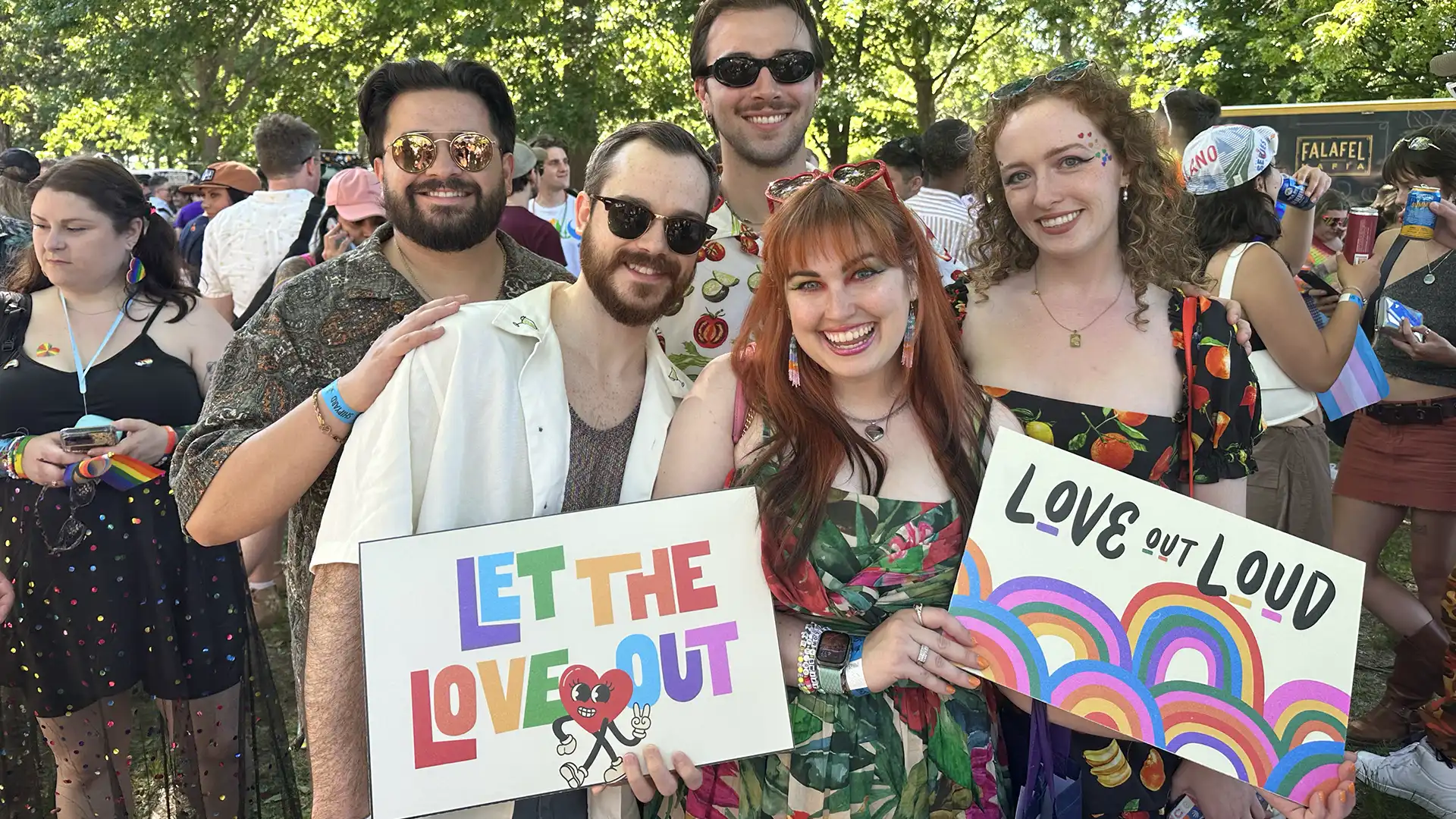 Pride parade goers with posters