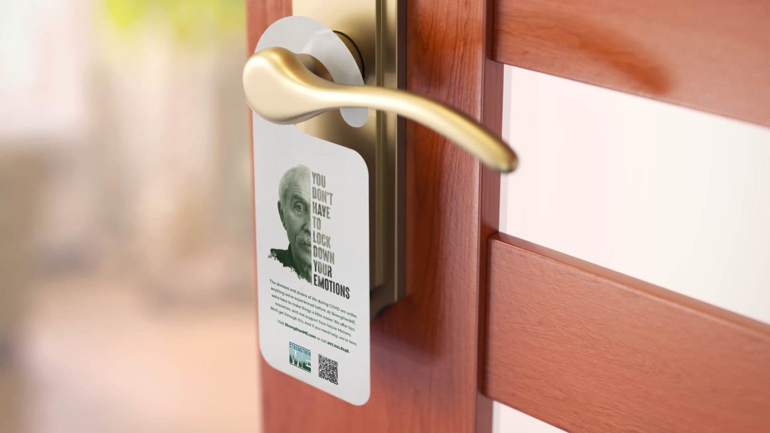 A door tag featuring a man, with half of his face visible. The other half displays a headline.