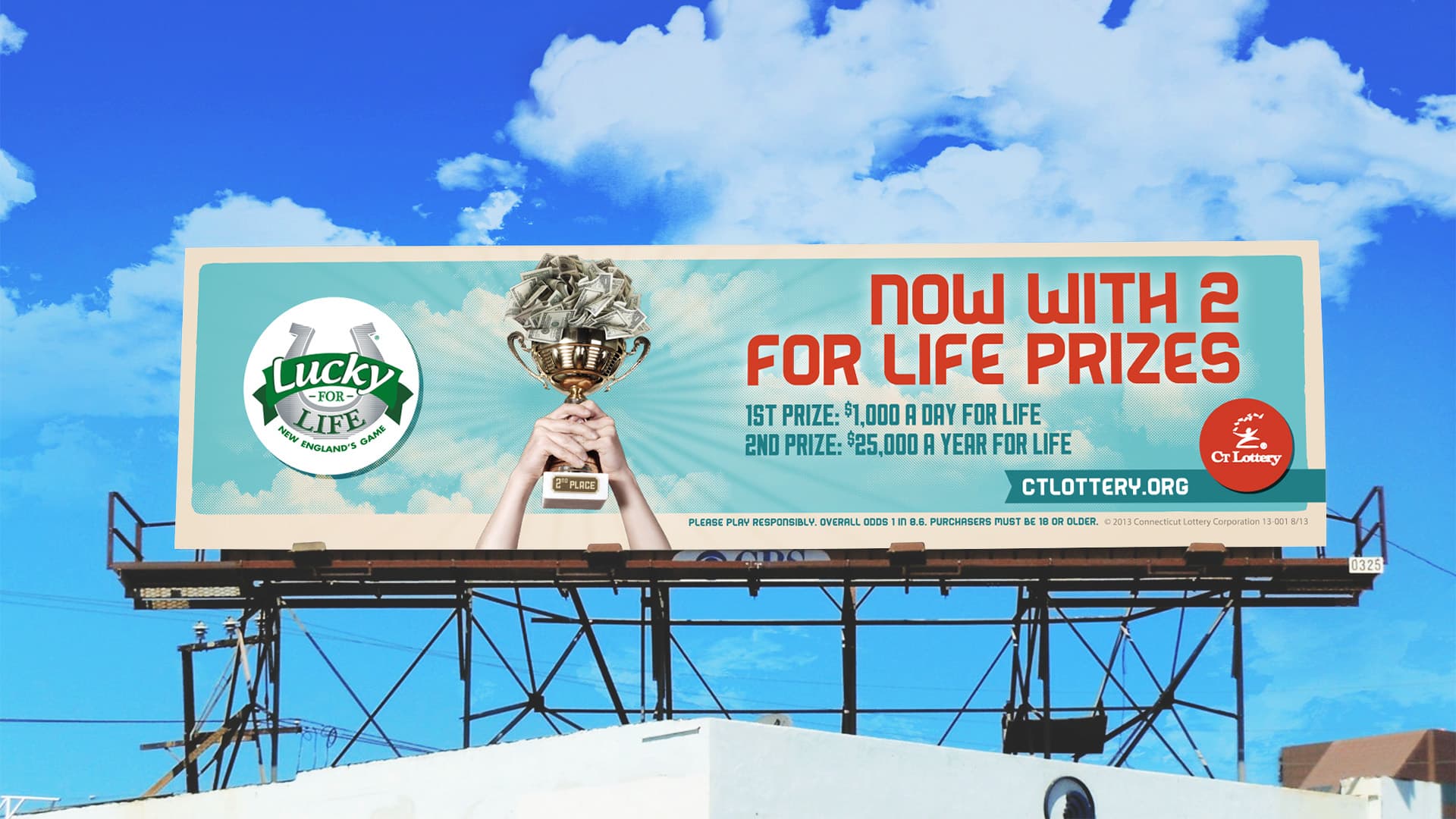 A OOH billboard showing a hand holding a trophy advertising Win for Life Connecticut Lottery