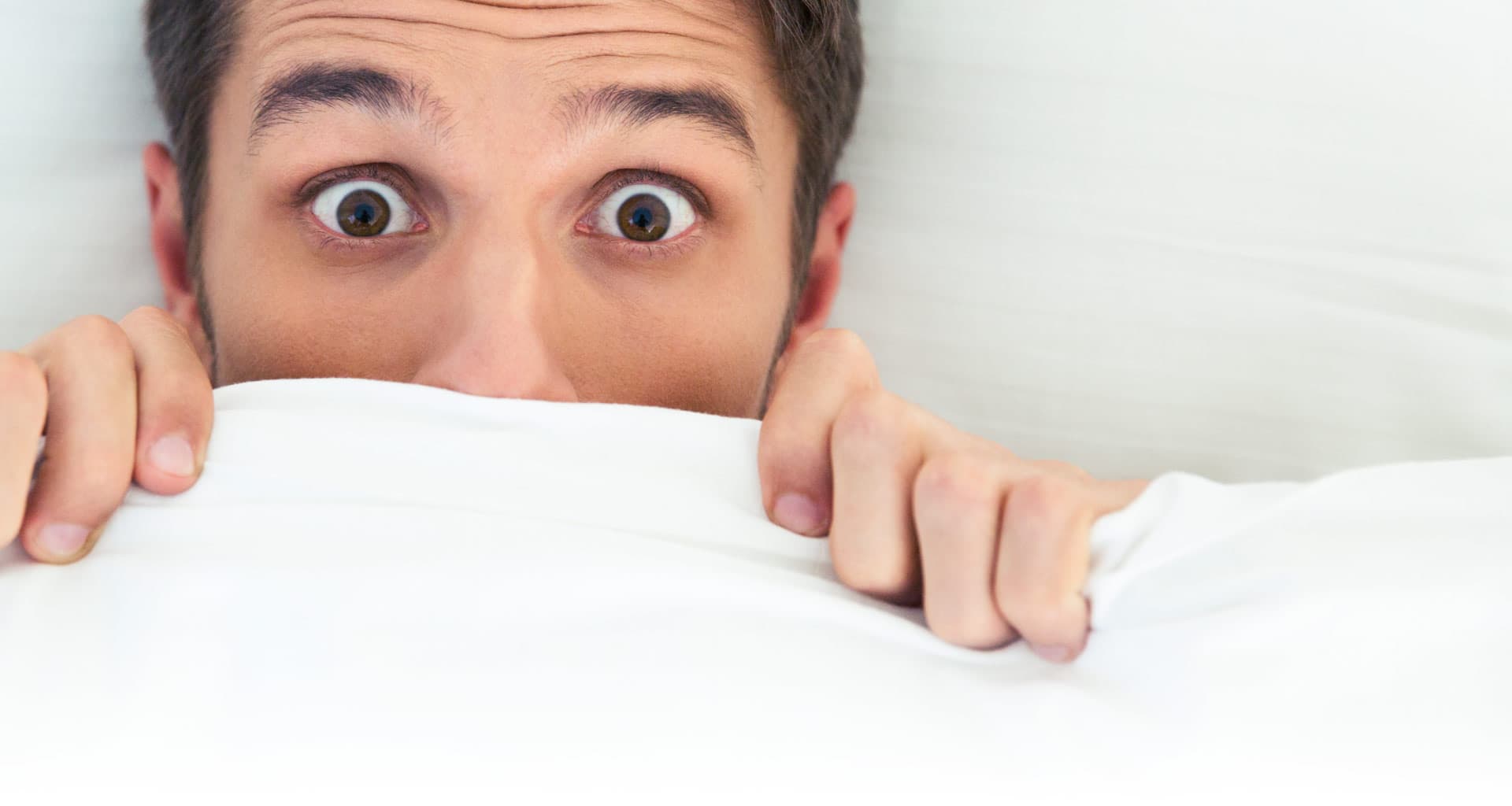 Man hiding behind his blanket