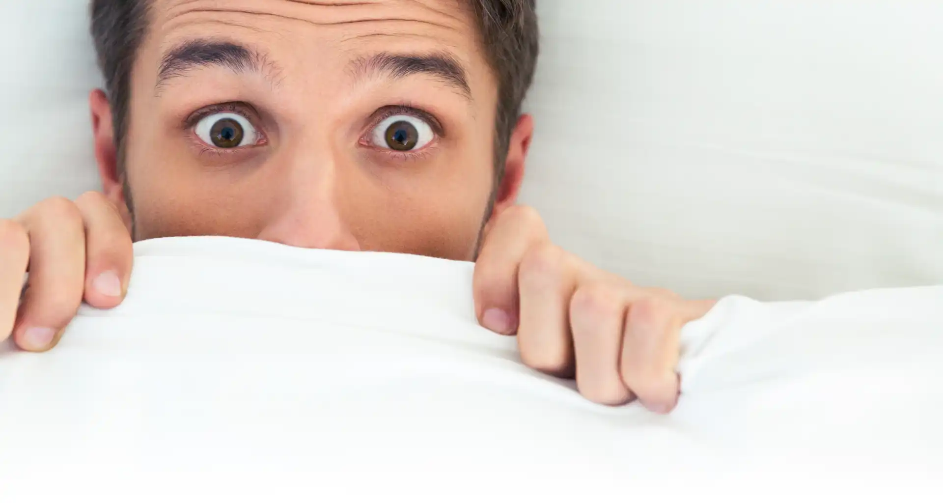 Man hiding behind his blanket