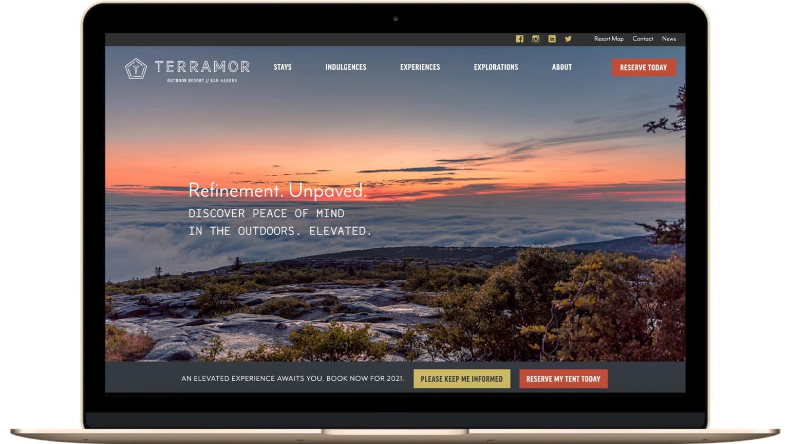 An image of a mountain summit displayed on a laptop.