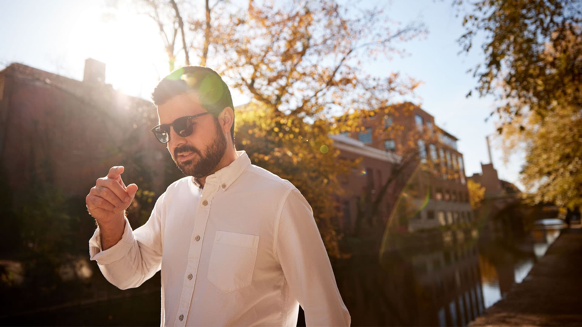 A man in sunglasses looks down