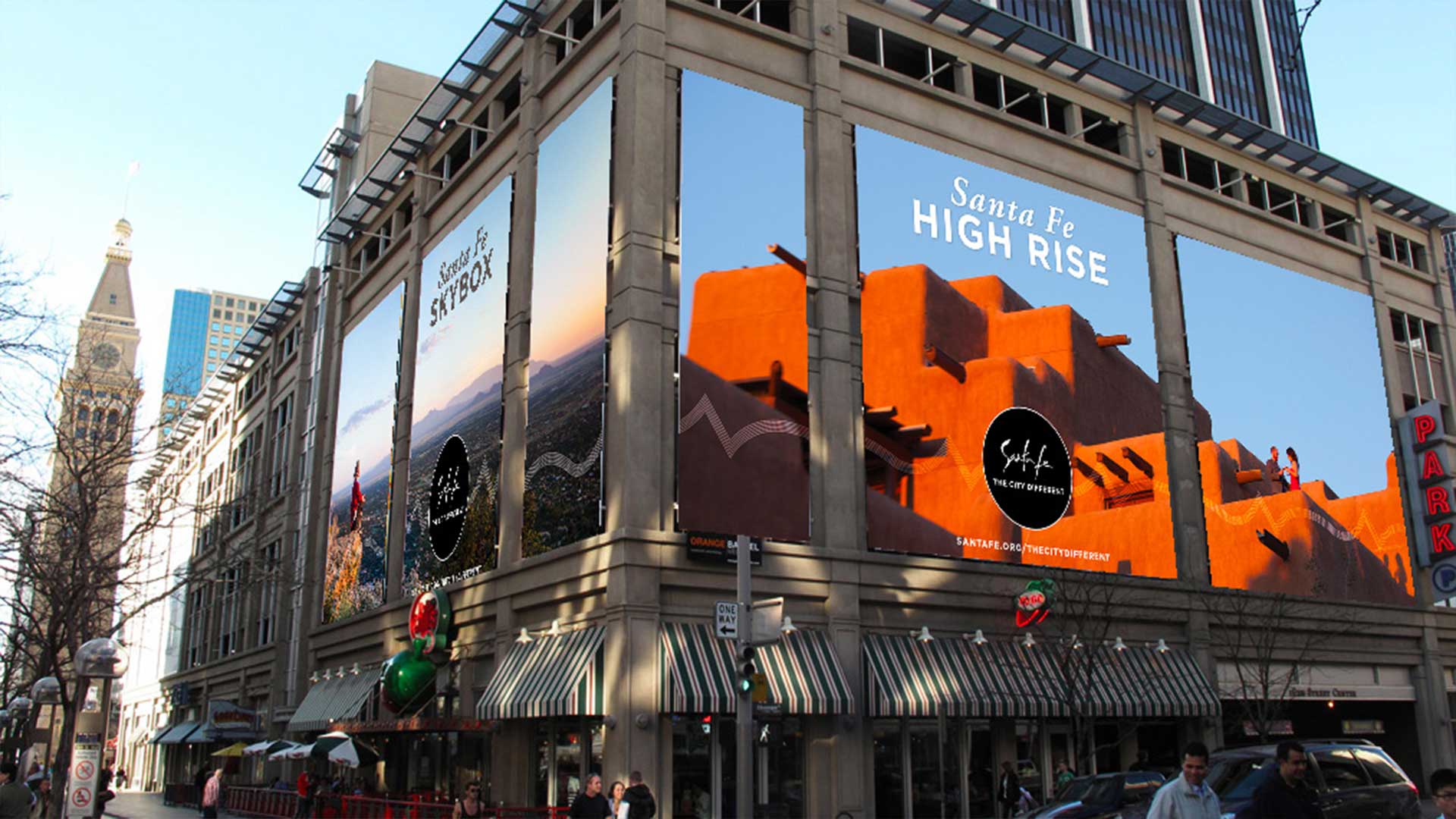An out-of-home placement on two sides of a building, showcasing scenic landmarks of Santa Fe.
