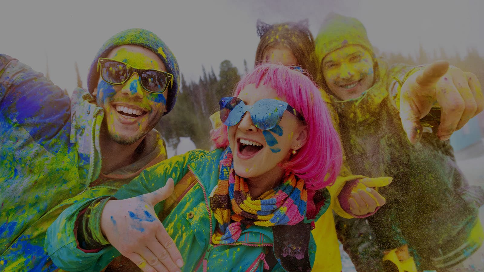 Participants in a color run smiling and wearing crazy outfits