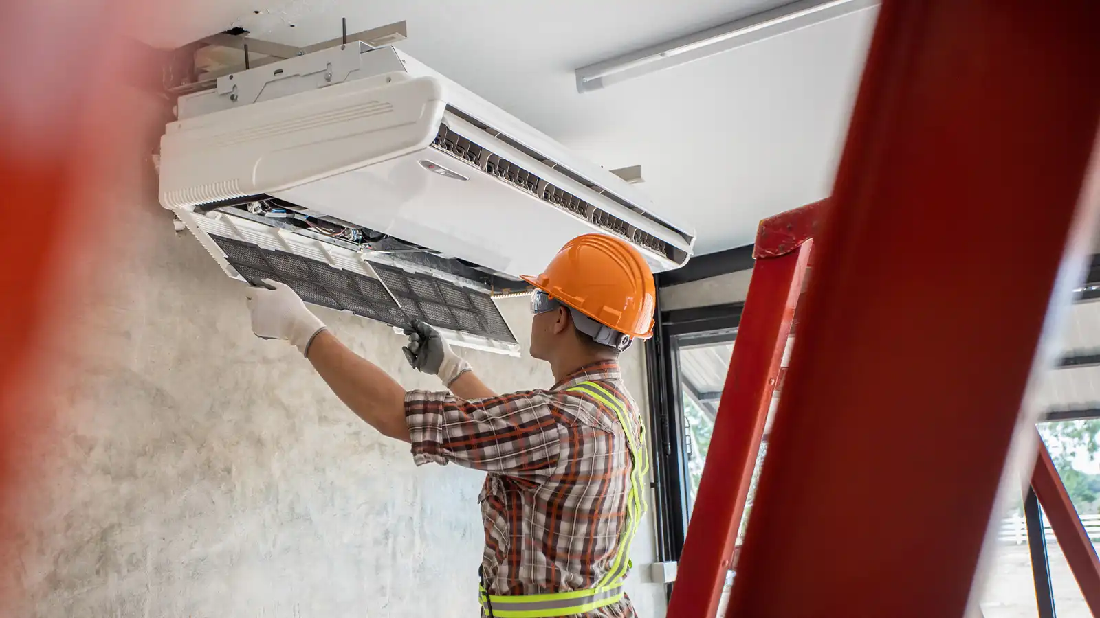 Contractor installing an air source heat pump
