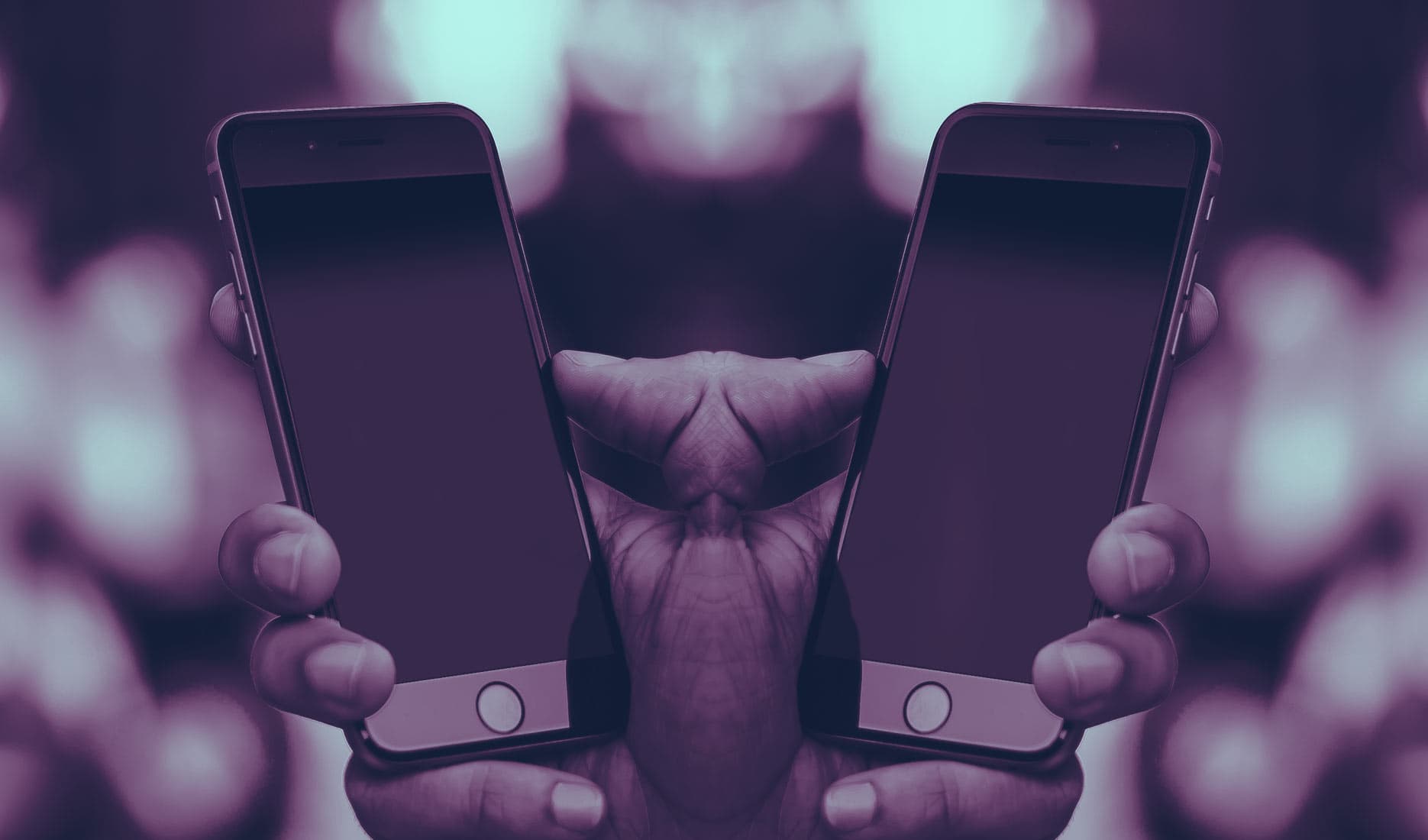 A mirror image of hands holding an iPhone