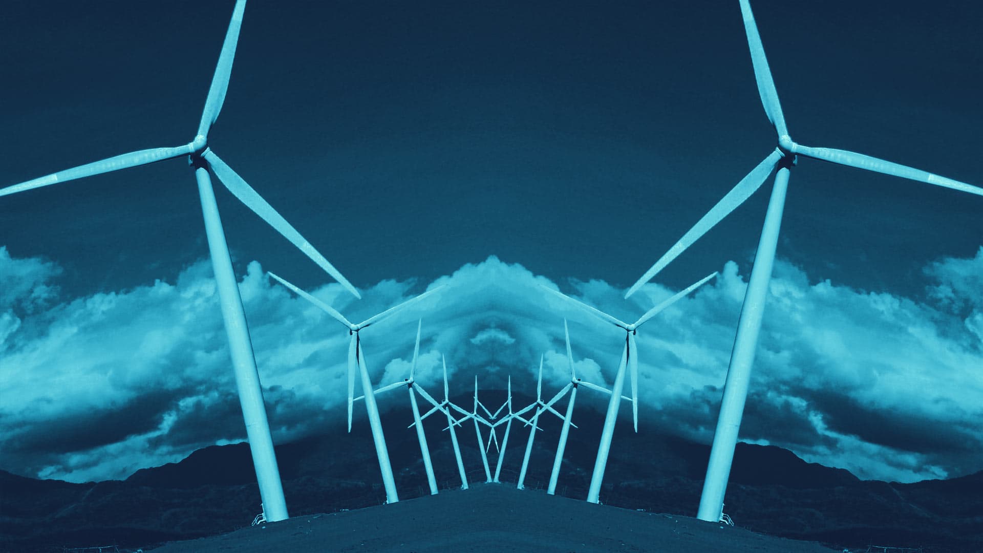 A mirror image of windmills against a sky background