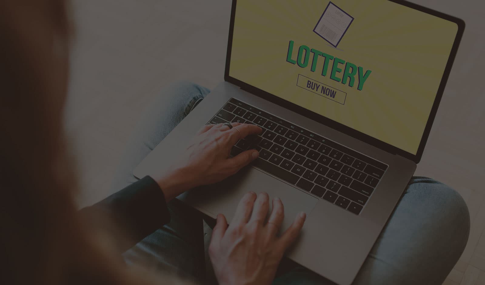 A person using a laptop to purchase lottery tickets online
